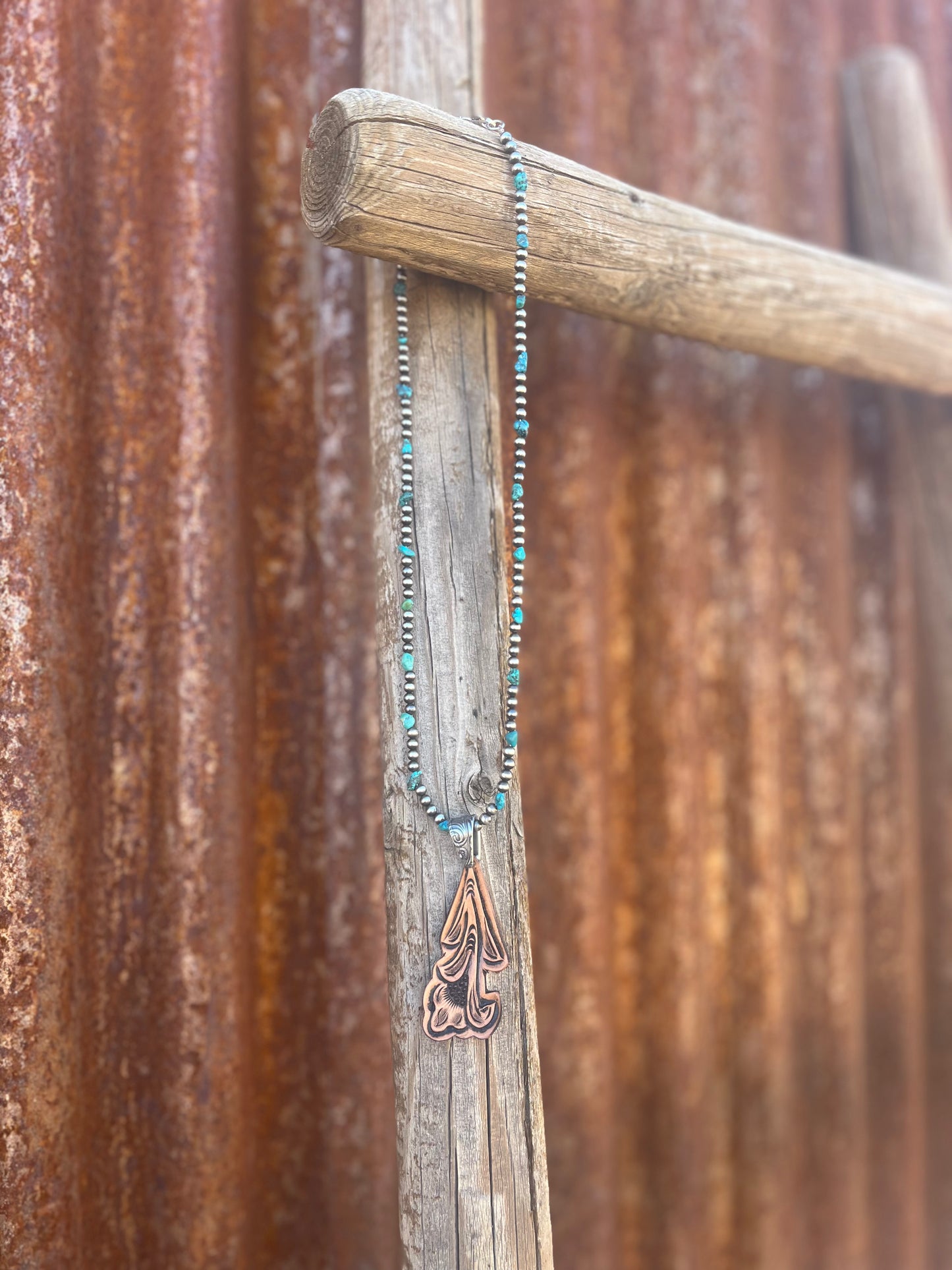 Floral tooled Pendant on Sterling Pearl Strand